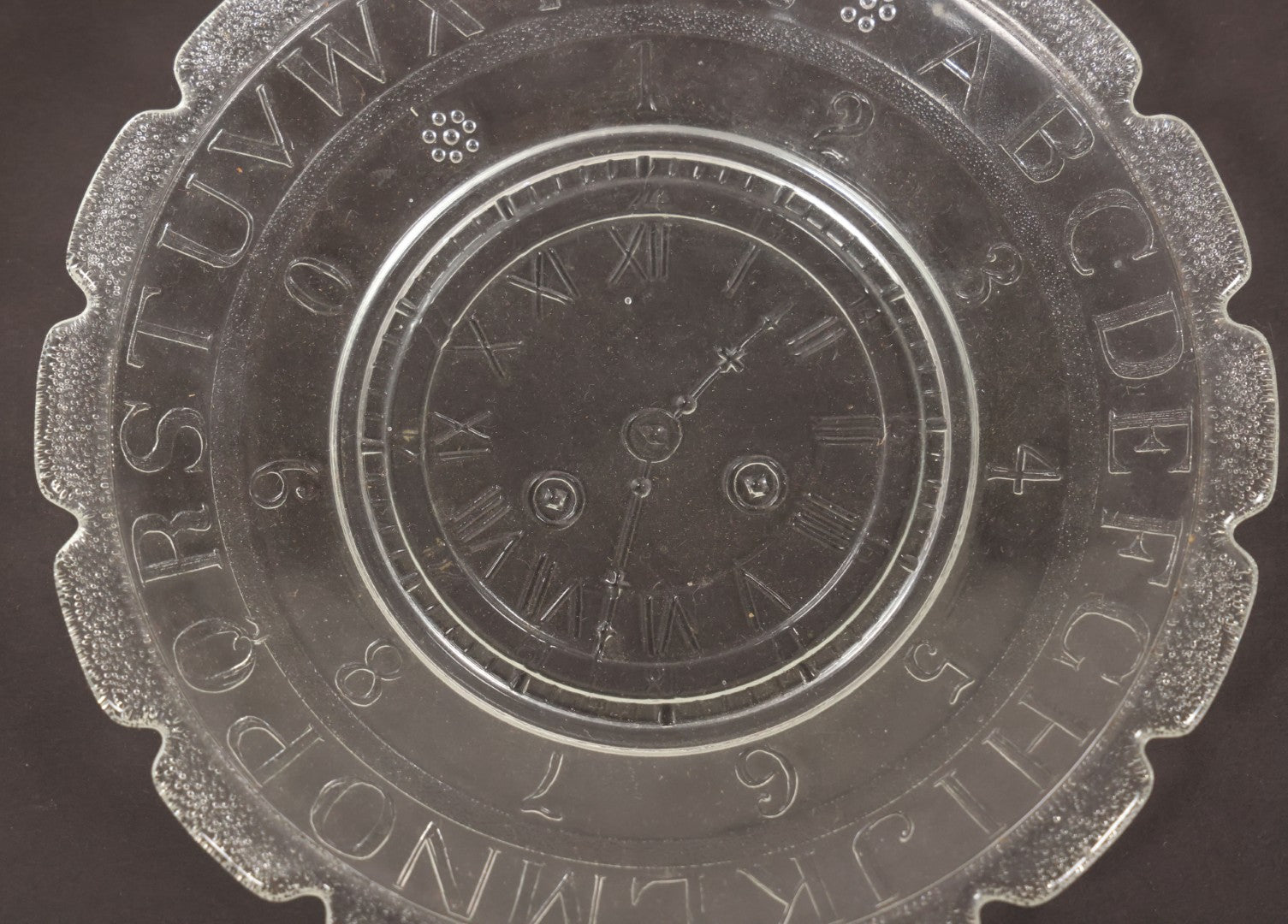 Lot 027 - Antique Early American Pattern Glass E.A.P.G. Alphabet Plate With Clock Motif, 7" Diameter