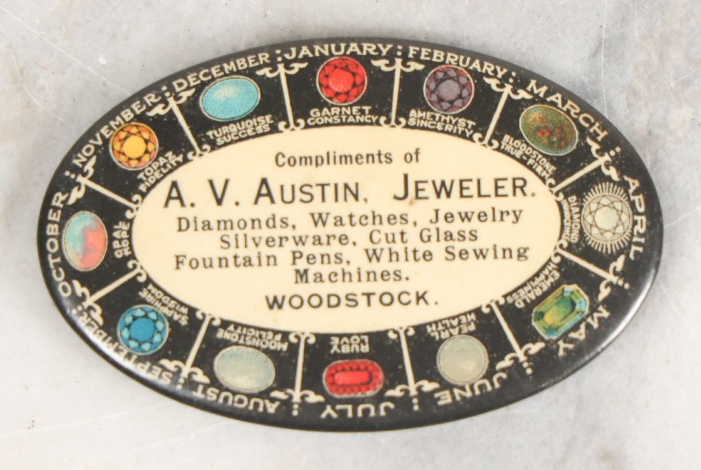 Lot 034 - Antique Advertising Pocket Mirror, Compliments Of A.V. Austin, Jewelry, With Birthstone Graphic Surround, Note Wear To Mirror