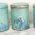Lot 040 - Three Piece Vintage Tin Lithograph Graduated Nesting Kitchen Canister Set Including Tea, Coffee, And Sugar With Blue Color And Scenes Of Agricultural Workers