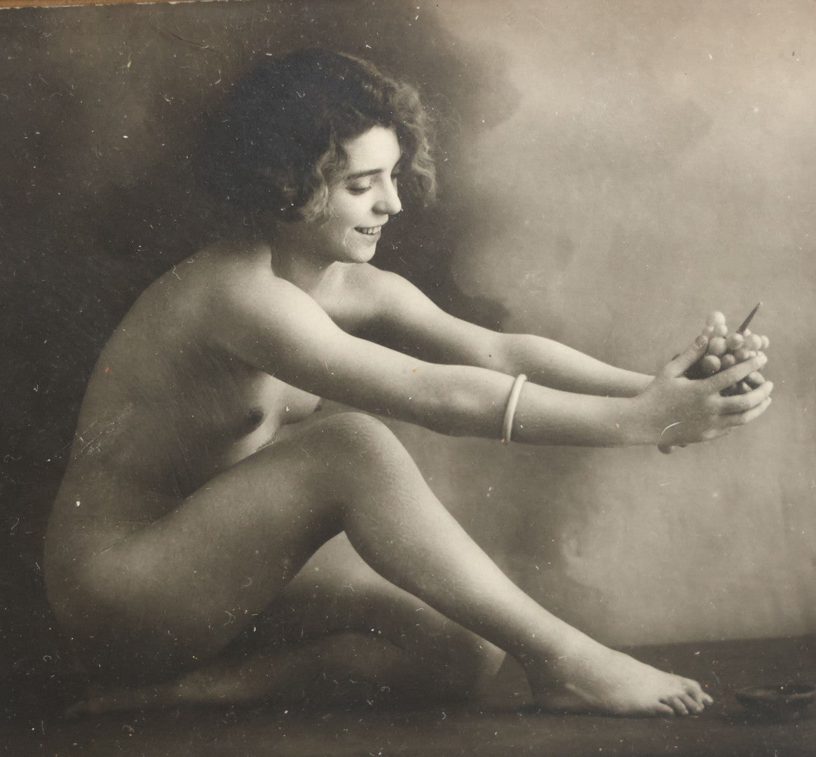 Lot 047 - Pair Of Antique French Nude Postcards Of Women Looking Fondly At Bundle Of Grapes, In Two Poses, Published By Armand Noyer, Series No. 4391, Made In France, In Matching Vintage Frames, 8" x 6" each