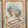 Lot 053 - Antique Nabisco National Biscuit Company Lithographed Advertisement With Woman In Blue Hat And Cherubs, Copyright 1902, In Vintage Frame, 7-1/8" x 9-1/2"