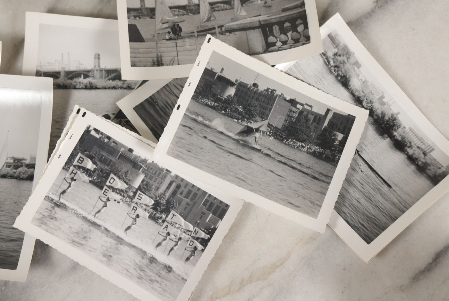 Lot 088 - Grouping Of 25 Vintage Black And White Photographs Of Boating On The Charles River, Boston And Cambridge Mass., Including Photo Of Boston Herald Water Skiers, Sailboats, And Rowing, With Landmarks Including Longfellow Bridge, Universities