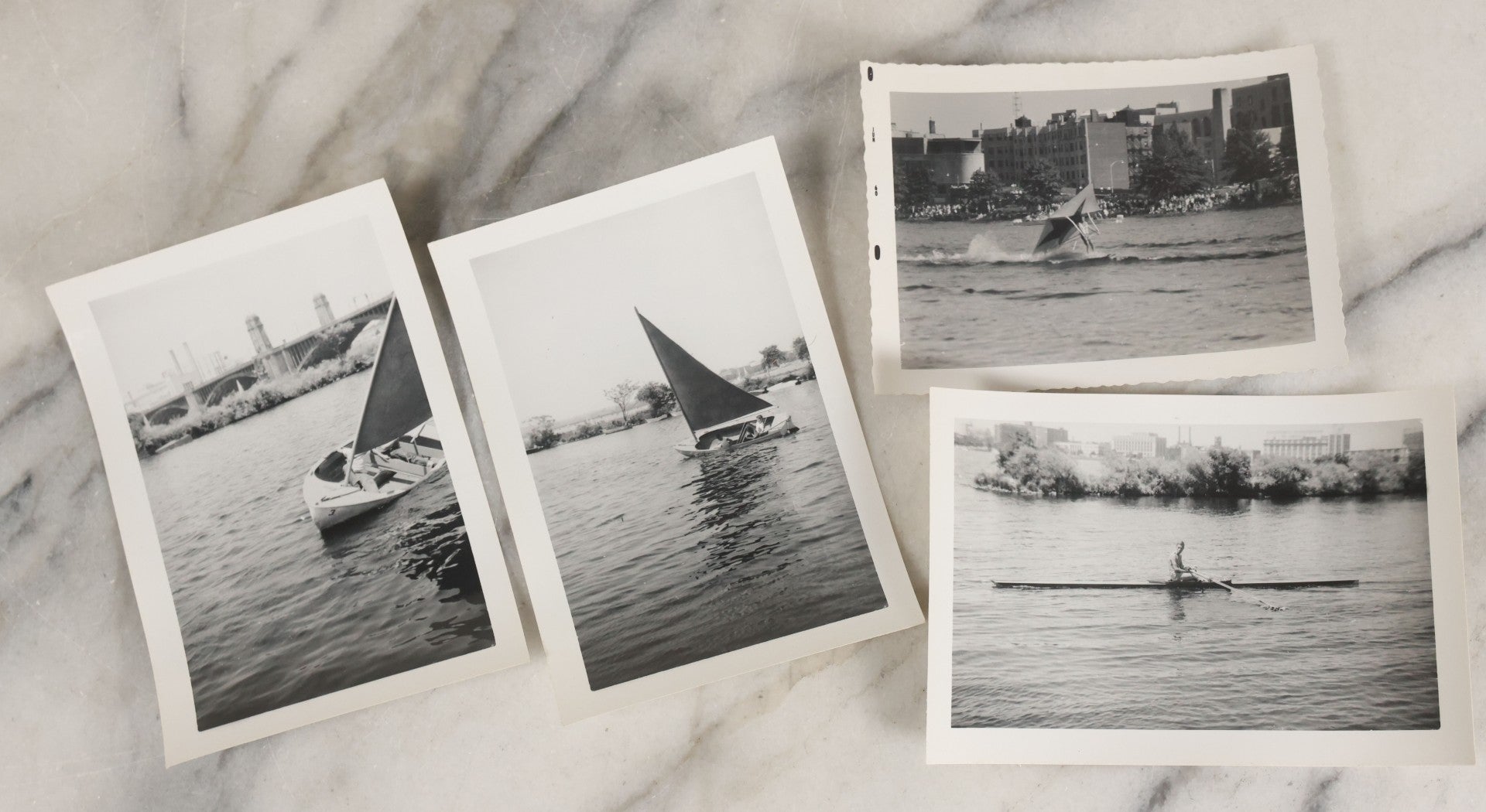Lot 088 - Grouping Of 25 Vintage Black And White Photographs Of Boating On The Charles River, Boston And Cambridge Mass., Including Photo Of Boston Herald Water Skiers, Sailboats, And Rowing, With Landmarks Including Longfellow Bridge, Universities