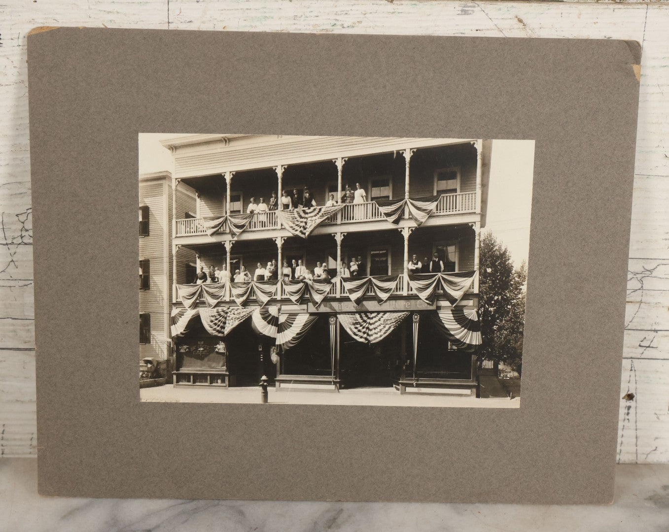 Lot 093 - Antique Boarded Photograph Of Spectators Watching From Balconies During A Patriotic Celebration With Bunting And American Flags In Photo
