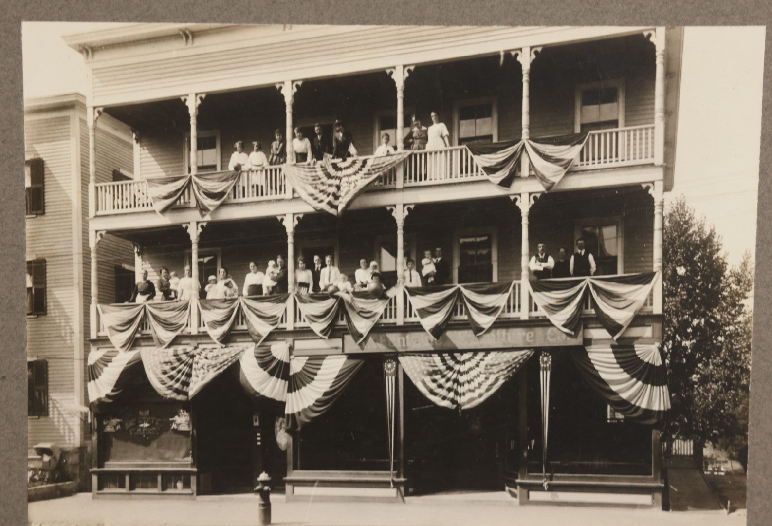 Lot 093 - Antique Boarded Photograph Of Spectators Watching From Balconies During A Patriotic Celebration With Bunting And American Flags In Photo