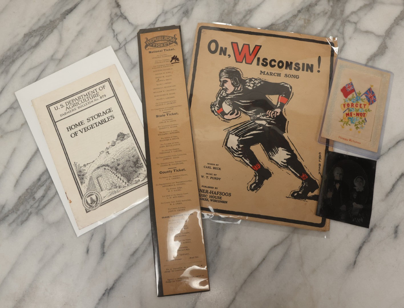 Lot 102 - Five Piece Ephemera Grouping Including "On, Wisconsin! March Song," Embroidered Forget Me Not Postcard, U.S.D.A. "Home Storage Of Vegetables" Booklet, Republican Election Ticket, And Tintype Of Elderly Man And Woman