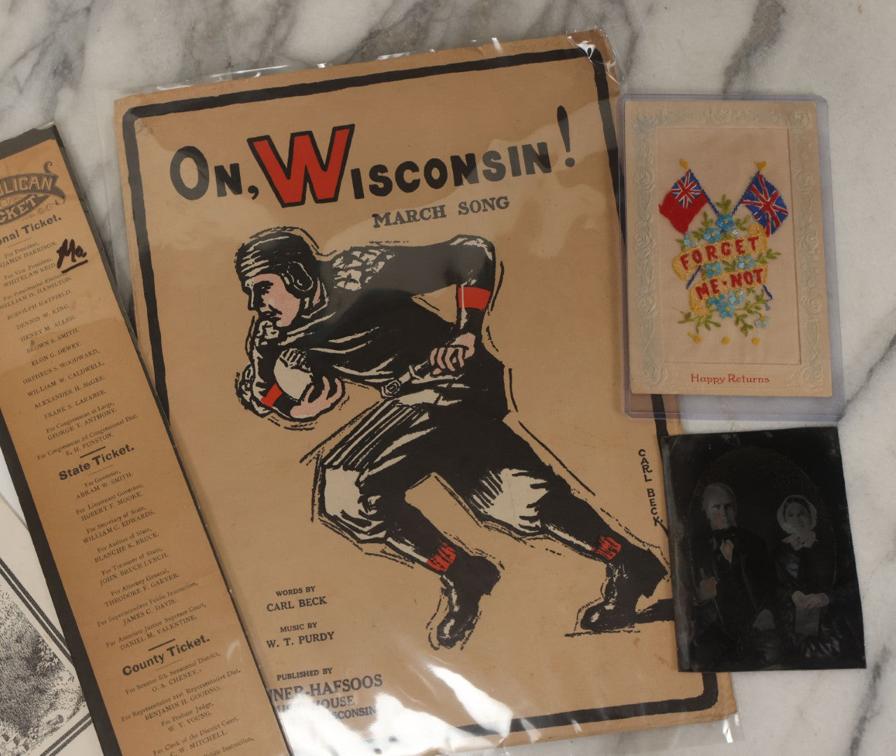 Lot 102 - Five Piece Ephemera Grouping Including "On, Wisconsin! March Song," Embroidered Forget Me Not Postcard, U.S.D.A. "Home Storage Of Vegetables" Booklet, Republican Election Ticket, And Tintype Of Elderly Man And Woman