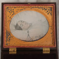 Lot 001 - Antique Victorian 1/6th Plate Color Tinted Daguerreotype Post Mortem Photograph Of A Deceased Woman At Rest On White Linens, In Original Thermoplastic "Genuine Union Case," Patented By S. Peck, 1854 And H. Halverson, 1855
