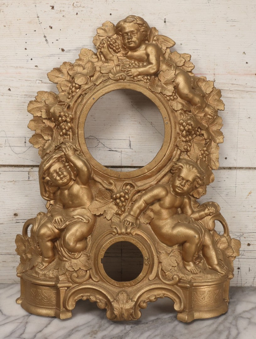 Lot 009 - Antique Gold Painted Cast Metal Figural Clock Front With Cherubs And Grapes Motifs, Marked N. Muller, N.Y. No. 49 Patented 1856, 15" x 18-3/4"