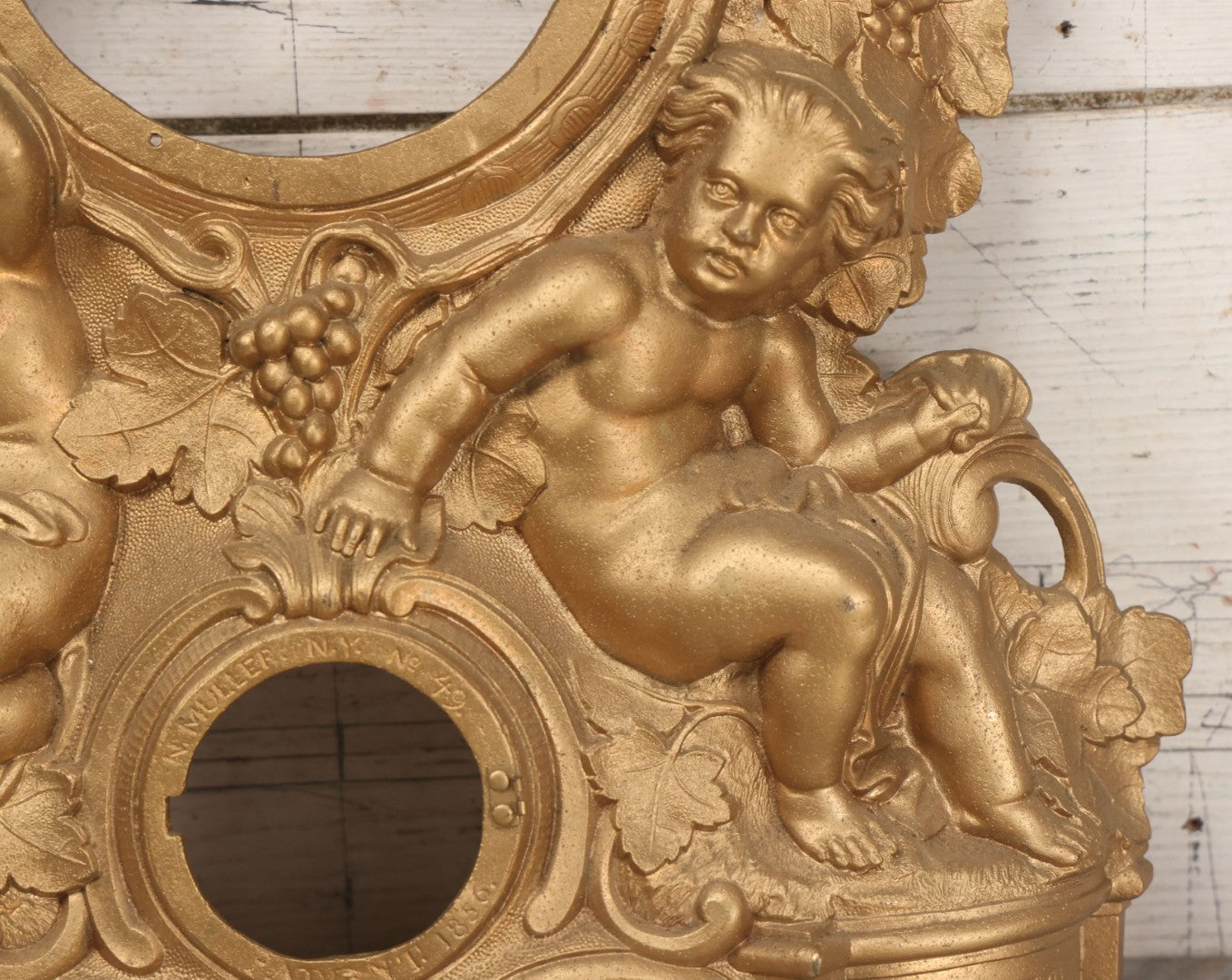 Lot 009 - Antique Gold Painted Cast Metal Figural Clock Front With Cherubs And Grapes Motifs, Marked N. Muller, N.Y. No. 49 Patented 1856, 15" x 18-3/4"