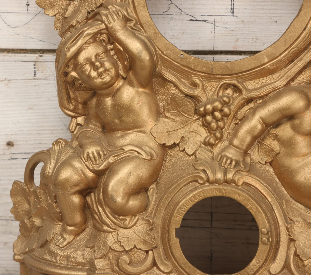 Lot 009 - Antique Gold Painted Cast Metal Figural Clock Front With Cherubs And Grapes Motifs, Marked N. Muller, N.Y. No. 49 Patented 1856, 15" x 18-3/4"