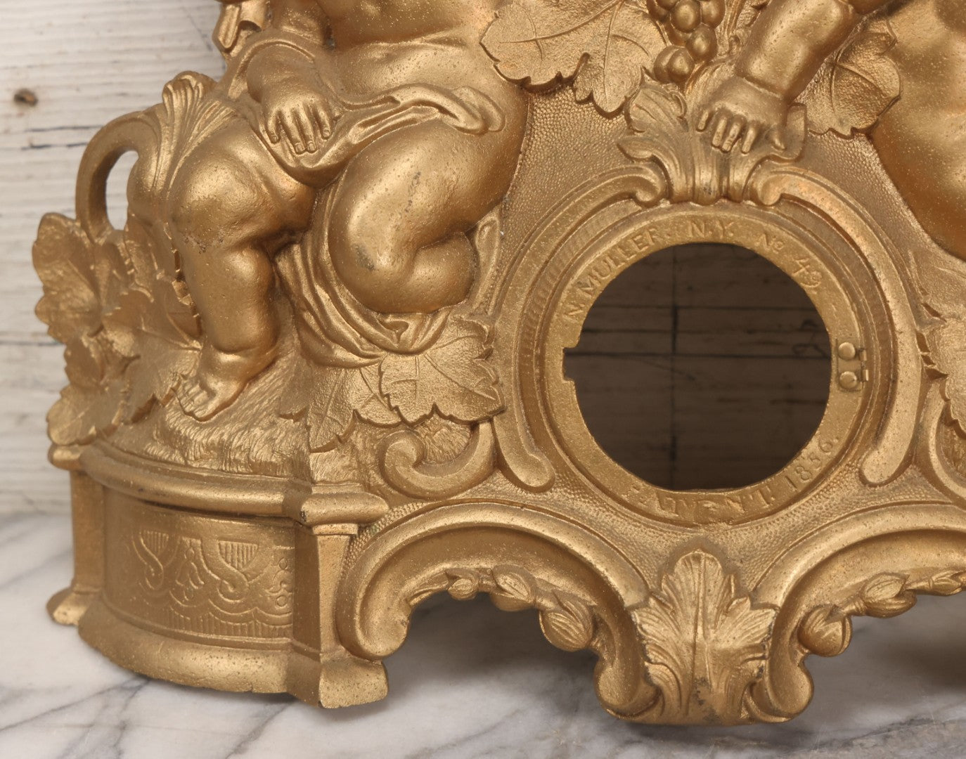 Lot 009 - Antique Gold Painted Cast Metal Figural Clock Front With Cherubs And Grapes Motifs, Marked N. Muller, N.Y. No. 49 Patented 1856, 15" x 18-3/4"