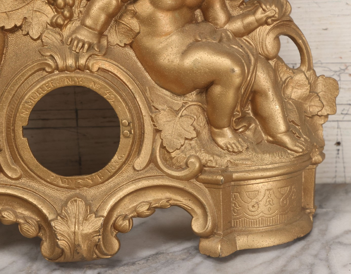 Lot 009 - Antique Gold Painted Cast Metal Figural Clock Front With Cherubs And Grapes Motifs, Marked N. Muller, N.Y. No. 49 Patented 1856, 15" x 18-3/4"