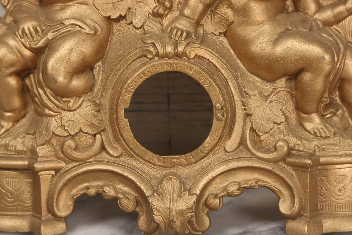 Lot 009 - Antique Gold Painted Cast Metal Figural Clock Front With Cherubs And Grapes Motifs, Marked N. Muller, N.Y. No. 49 Patented 1856, 15" x 18-3/4"