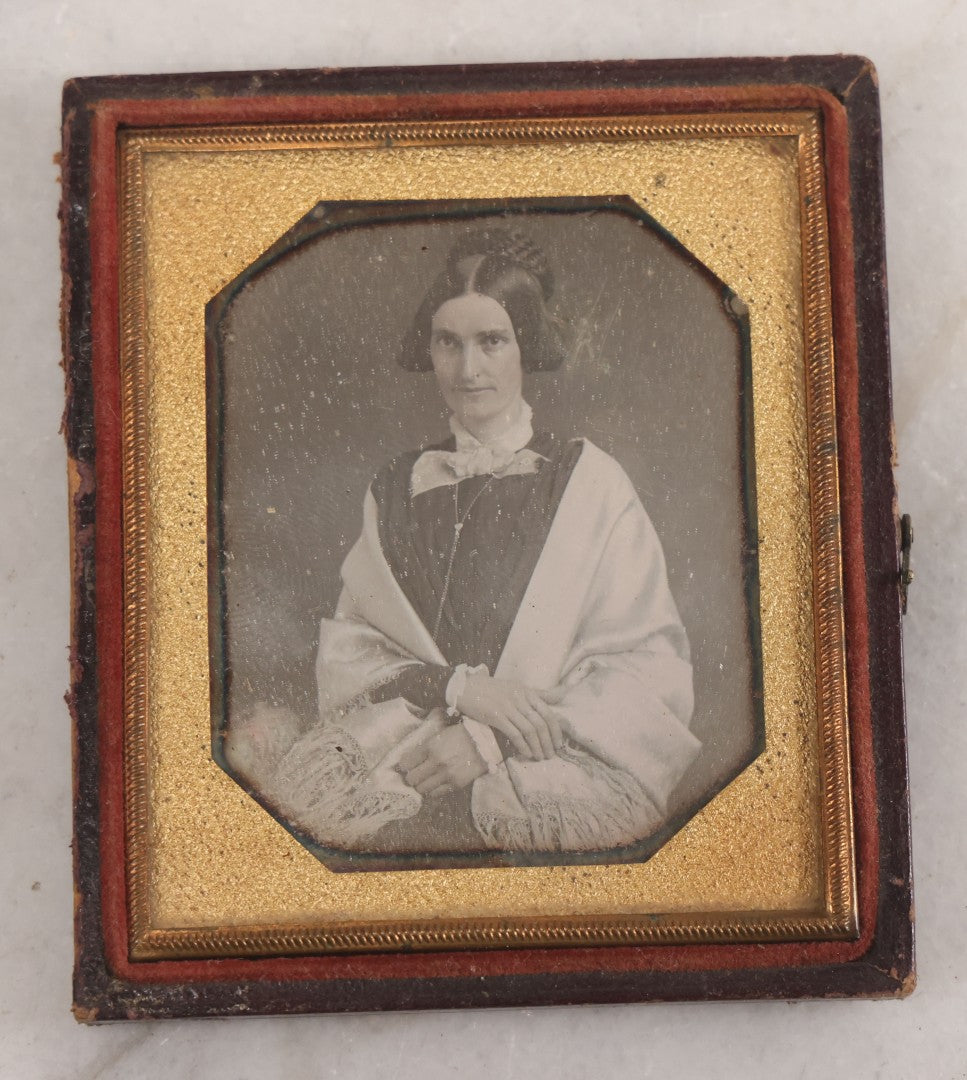 Lot 014 - Antique 1/6th Plate Daguerreotype Photograph Of A Woman Draped In Fabric Shawl With Unique Hairstyle In Half Leatherette Case With Eagle Motif