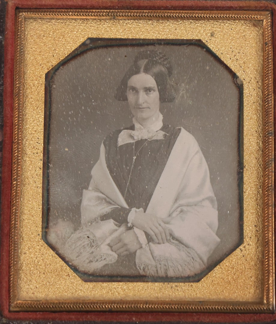 Lot 014 - Antique 1/6th Plate Daguerreotype Photograph Of A Woman Draped In Fabric Shawl With Unique Hairstyle In Half Leatherette Case With Eagle Motif