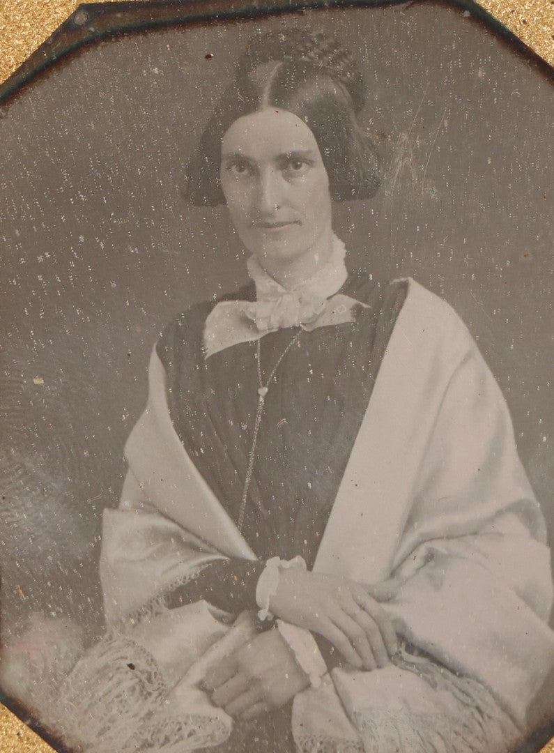 Lot 014 - Antique 1/6th Plate Daguerreotype Photograph Of A Woman Draped In Fabric Shawl With Unique Hairstyle In Half Leatherette Case With Eagle Motif