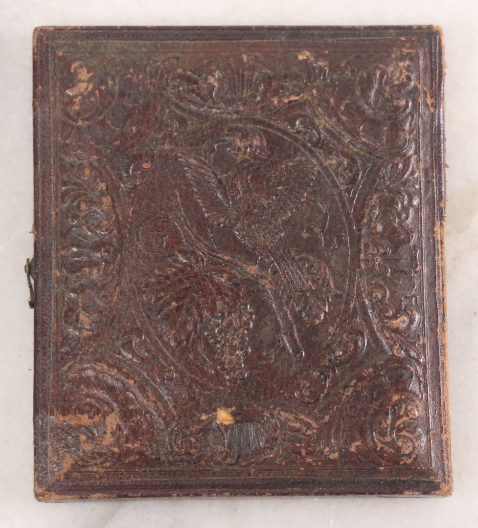 Lot 014 - Antique 1/6th Plate Daguerreotype Photograph Of A Woman Draped In Fabric Shawl With Unique Hairstyle In Half Leatherette Case With Eagle Motif