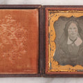 Lot 015 - Antique 1/9th Plate Daguerreotype Photograph Of Young Woman With Striking Eyes, White Collar, And Bonnet With Long Dark Lappets, In Full Intact Leatherette Union Case With Rose Motif