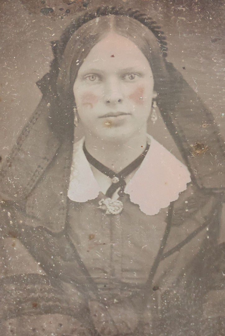 Lot 015 - Antique 1/9th Plate Daguerreotype Photograph Of Young Woman With Striking Eyes, White Collar, And Bonnet With Long Dark Lappets, In Full Intact Leatherette Union Case With Rose Motif