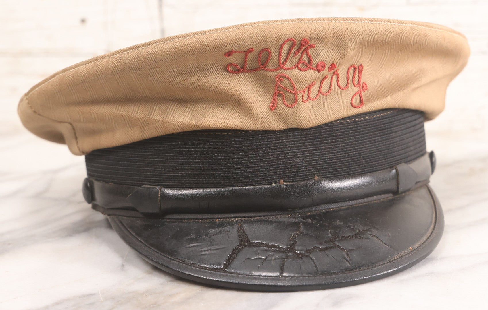 Lot 018 - Vintage "Tel's Dairy" Hand Embroidered Milkman's Cap With Red Stitching On Beige Fabric, Size 7-1/4