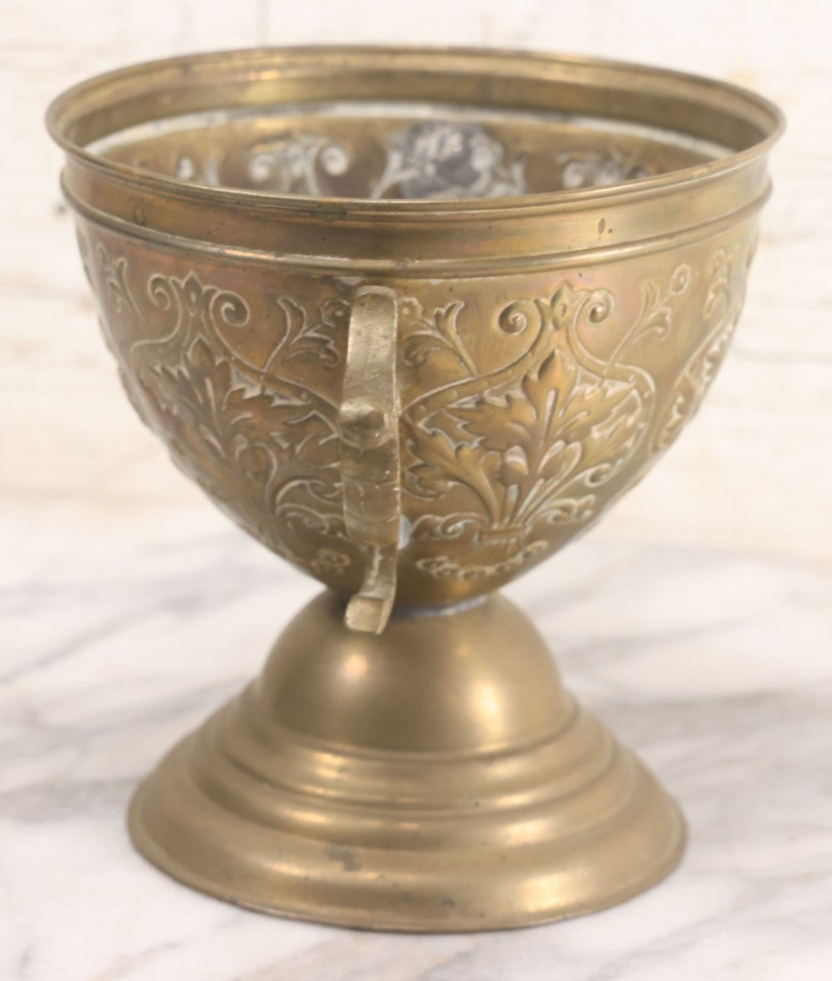 Lot 022 - Antique Pressed Brass Decorative Two-Handled Urn With Foliate Pattern Design And Weighted Base, 6-1/8" Height