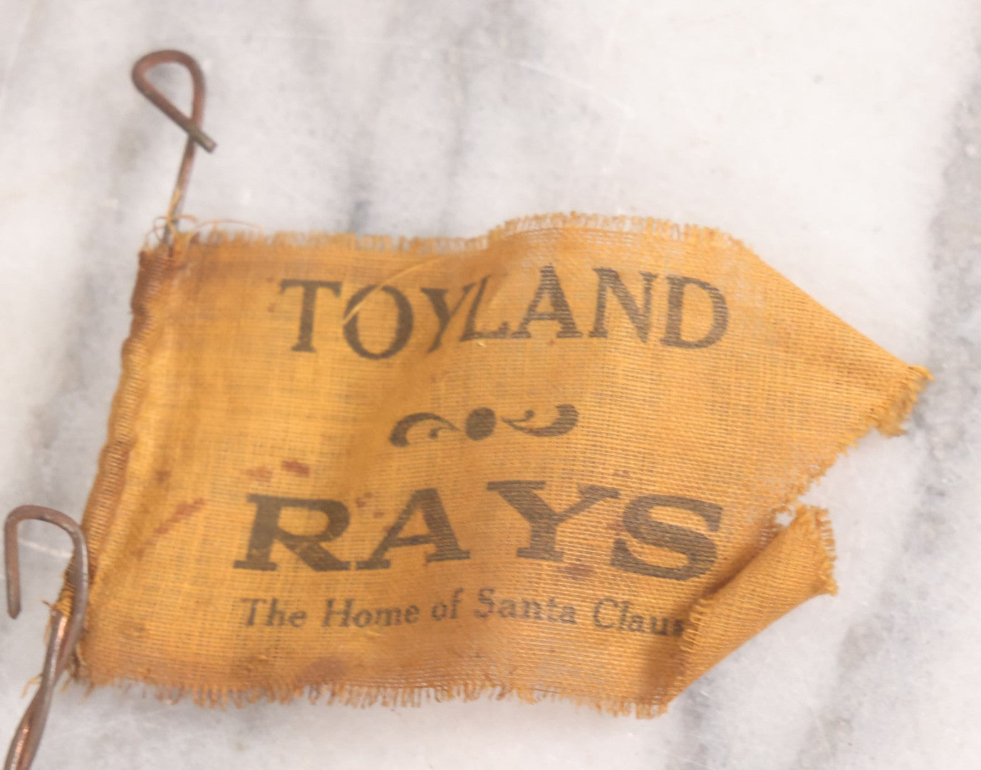 Lot 027 - Vintage Spinning Tin Fish Novelty Toy, Topped With Yellow Flag, "Toyland Rays: Home Of Santa Claus"
