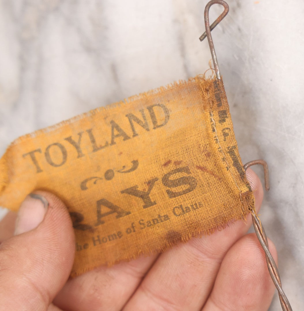 Lot 027 - Vintage Spinning Tin Fish Novelty Toy, Topped With Yellow Flag, "Toyland Rays: Home Of Santa Claus"