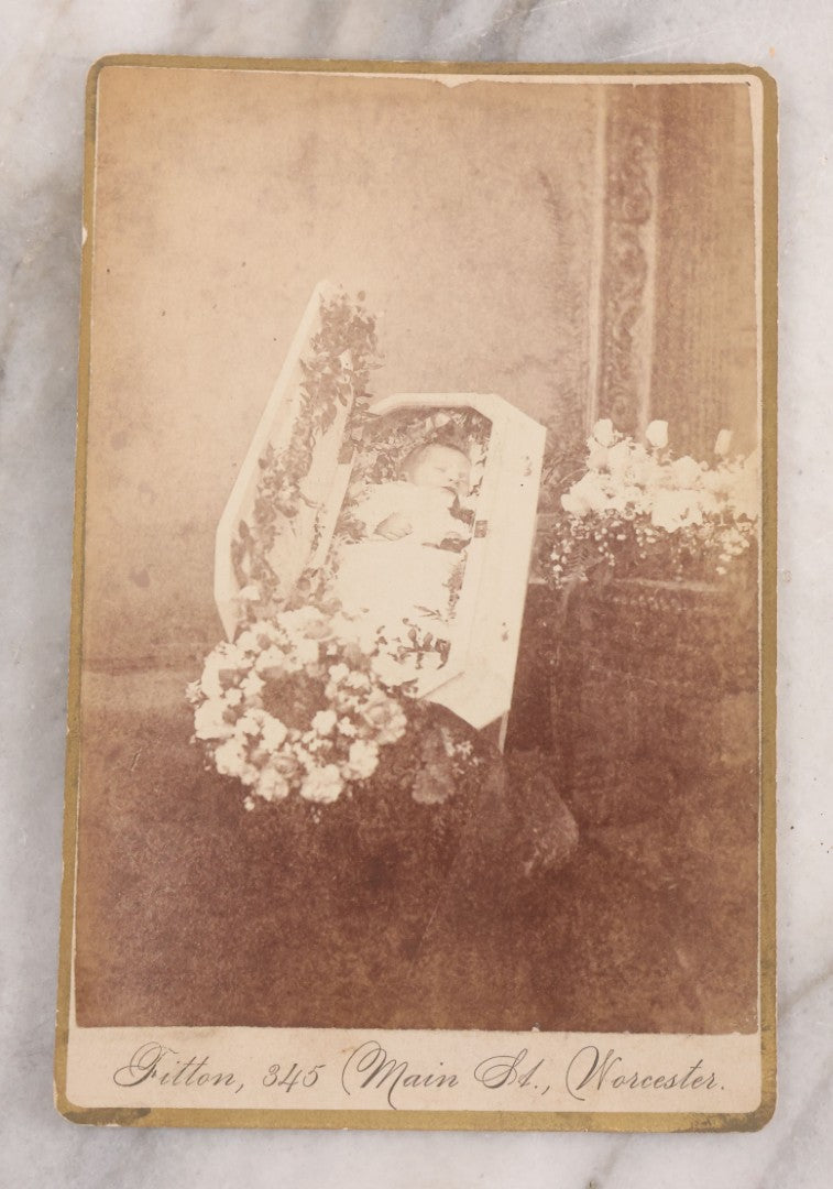 Lot 040 - Antique Victorian Post Mortem Cabinet Card Photograph Of A Deceased Infant In White Casket Surrounded By Flowers, Fitton, Photographer, Worcester, Massachusetts