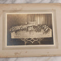 Lot 044 - Antique Boarded Funeral Photograph Of A Casket On Church Truck, Adorned With Flower Arrangements Including "Mother" Memorial