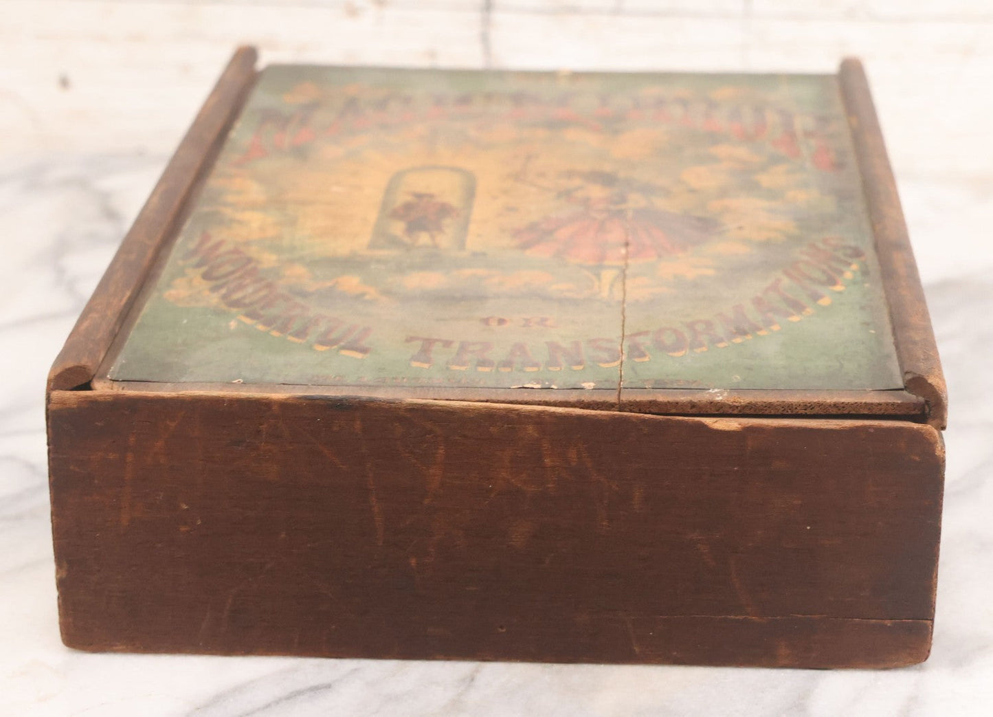 Lot 047 - Antique Lithographed Wooden Toy Box For "The Magic Mirror Or Wonderful Transformations" With Fairy Princess And Prince Characters, By Mcloughlin Bros., New York, Empty