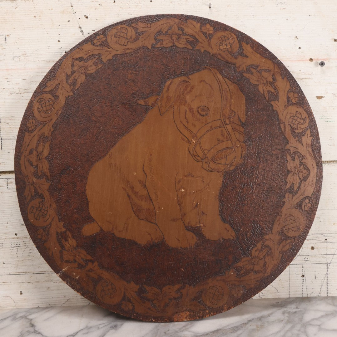 Lot 052 - Antique Pyrography Flemish Art Wood Burned Muzzled Puppy Dog Wall Hanger, 18" Diameter