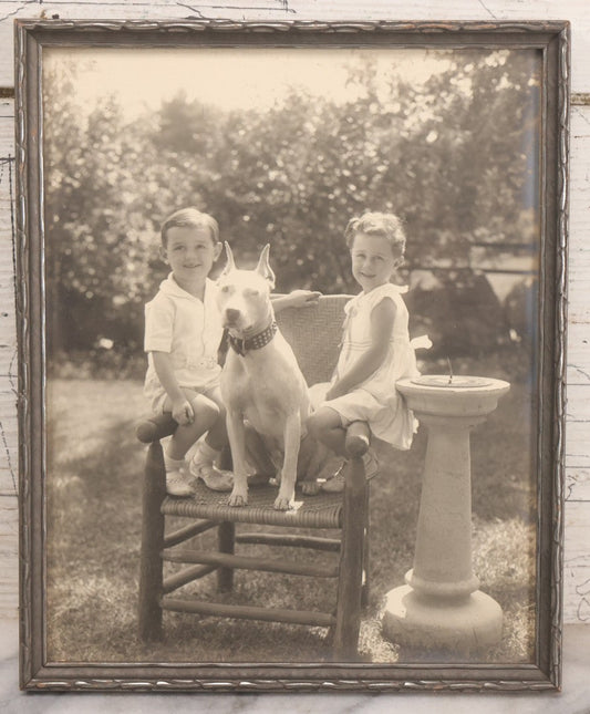 Lot 054 - Vintage Black And White Photograph Of Two Children Posing With Their English Bull Terrier Dog In Yard, In Frame, Framed By Donaldson's, Lowell, Massachusetts, 8-1/8" x 9-7/8"