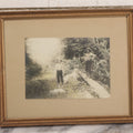 Lot 055 - Antique Green Tinted Black And White Photograph Of Two Boys Posing With Their Yellow Labrador Retriever Dog In The Woods, In Frame, 10-5/8" x 8-3/4"