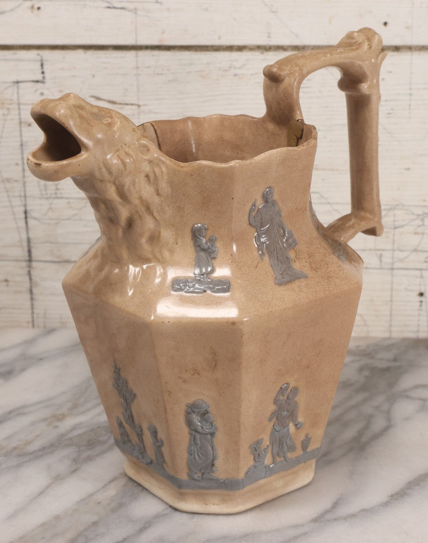 Lot 058 - Antique White Ironstone Pitcher With Figural Lion Head Spout, Blue Molded Neoclassical Figures, Note Damaged With Old Repairs, 9-3/4" Height