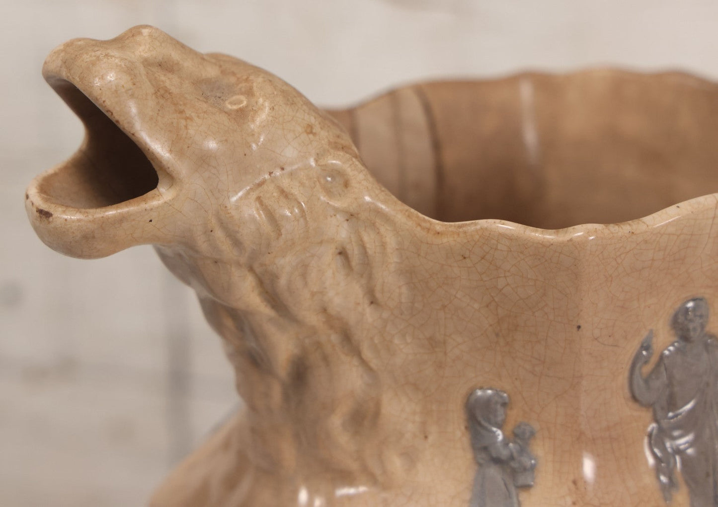 Lot 058 - Antique White Ironstone Pitcher With Figural Lion Head Spout, Blue Molded Neoclassical Figures, Note Damaged With Old Repairs, 9-3/4" Height