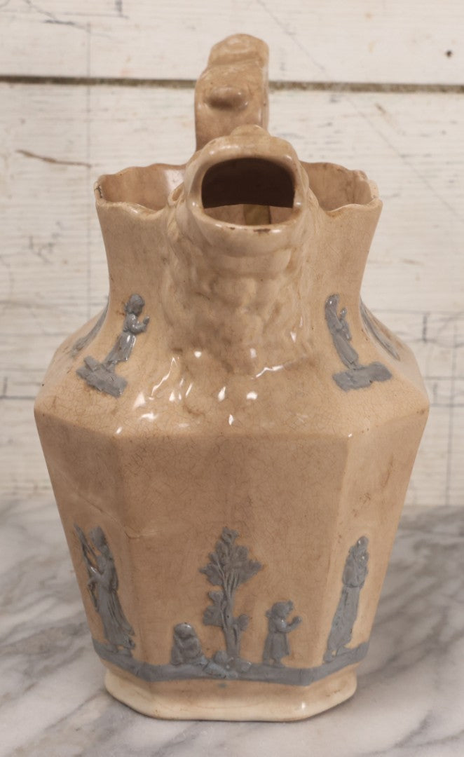 Lot 058 - Antique White Ironstone Pitcher With Figural Lion Head Spout, Blue Molded Neoclassical Figures, Note Damaged With Old Repairs, 9-3/4" Height