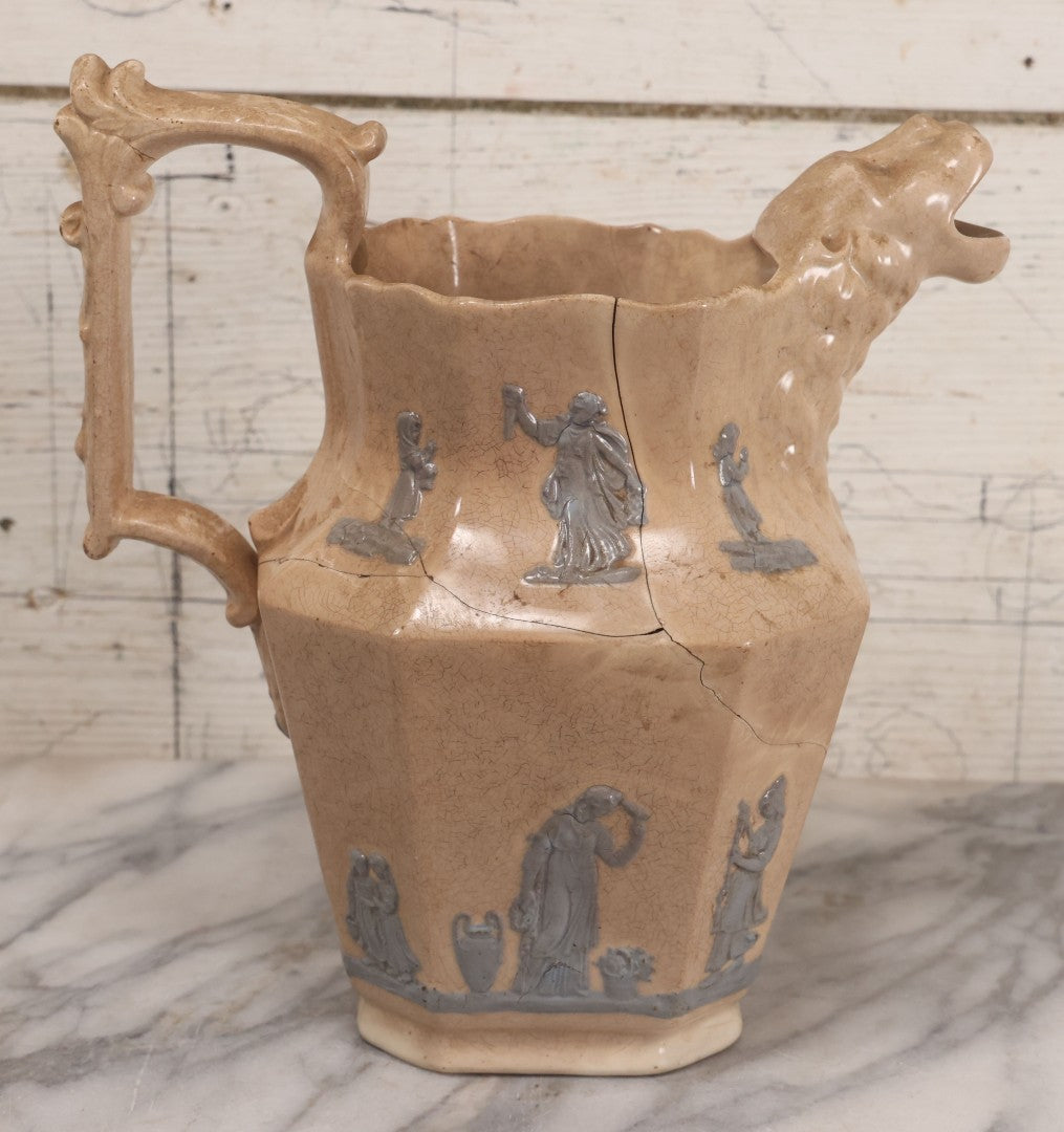 Lot 058 - Antique White Ironstone Pitcher With Figural Lion Head Spout, Blue Molded Neoclassical Figures, Note Damaged With Old Repairs, 9-3/4" Height