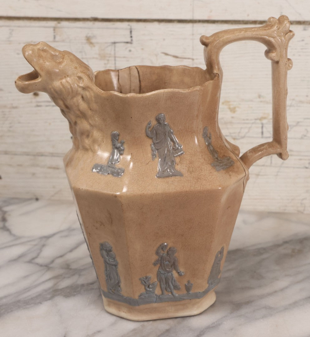 Lot 058 - Antique White Ironstone Pitcher With Figural Lion Head Spout, Blue Molded Neoclassical Figures, Note Damaged With Old Repairs, 9-3/4" Height