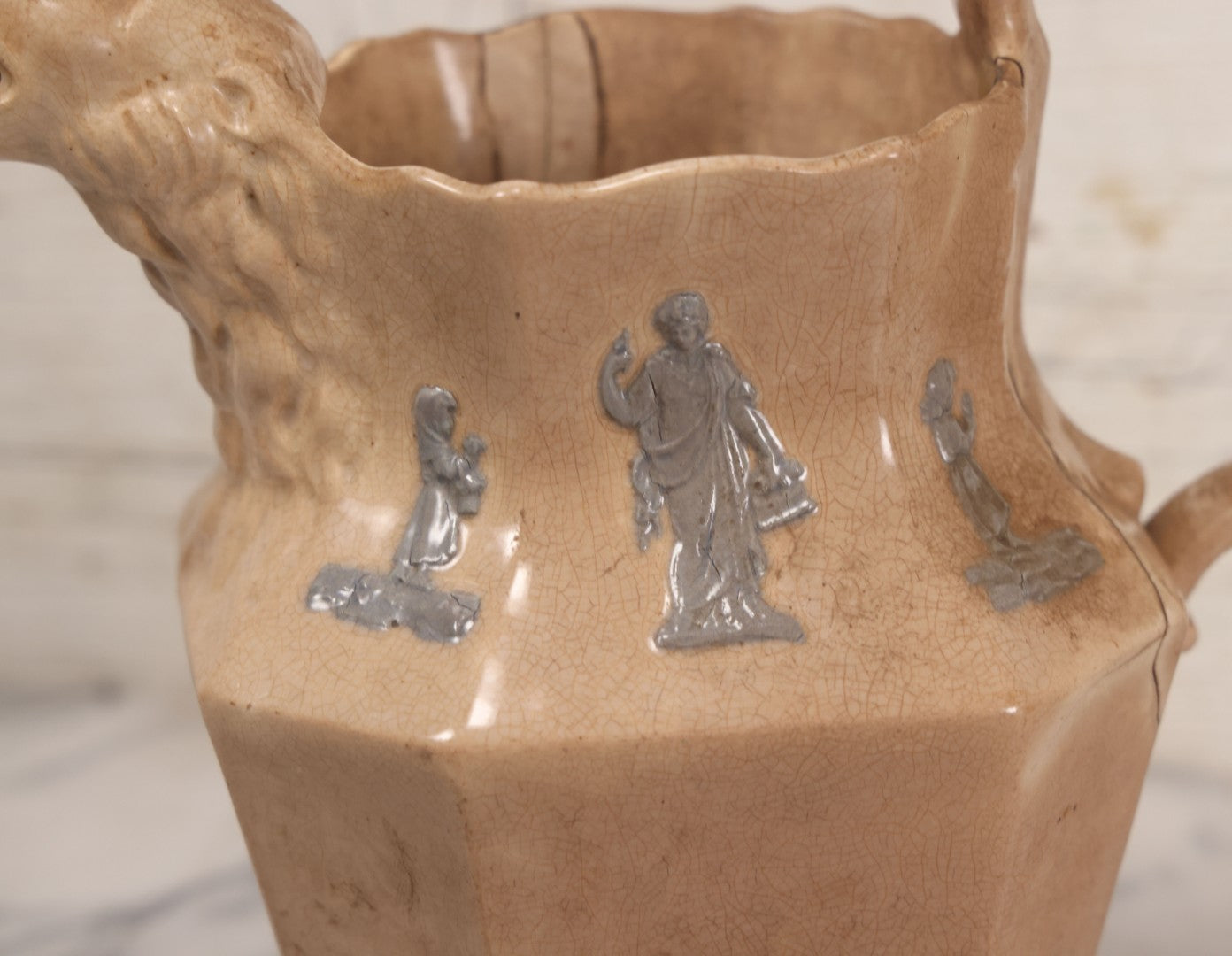 Lot 058 - Antique White Ironstone Pitcher With Figural Lion Head Spout, Blue Molded Neoclassical Figures, Note Damaged With Old Repairs, 9-3/4" Height