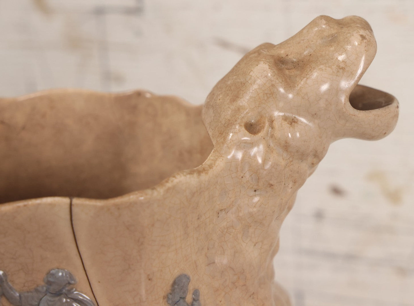 Lot 058 - Antique White Ironstone Pitcher With Figural Lion Head Spout, Blue Molded Neoclassical Figures, Note Damaged With Old Repairs, 9-3/4" Height