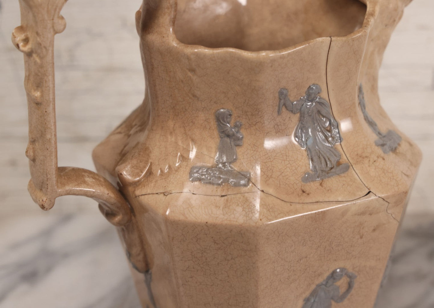 Lot 058 - Antique White Ironstone Pitcher With Figural Lion Head Spout, Blue Molded Neoclassical Figures, Note Damaged With Old Repairs, 9-3/4" Height