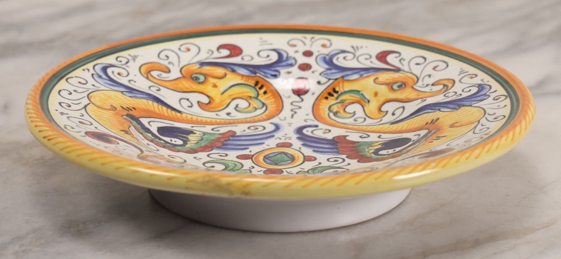 Lot 060 - Vintage Hand Painted Italian Deruta Majolica With Stylized Dolphins, Sea Monsters, Raffaellesco Design, Signed "S. Volpi, Deruta, II," 6-7/8" Diameter