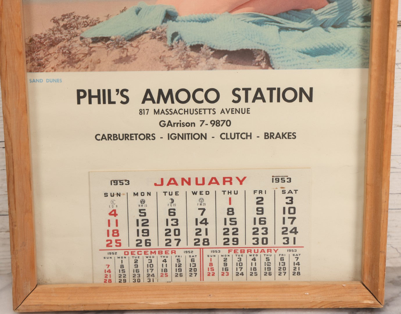 Lot 076 - Vintage Nude Woman Photo Pin-Up 1953 Calendar, "Sand Dunes," Advertisement For Phil's Amoco Station, Cambridge, Massachusetts, In Frame, 11-3/4" x 21-3/8"