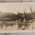 Lot 100 - Single Antique Snapshot Photograph Of A Man Crossing A River On A Makeshift Rope And Pulley Trolley, Taken In New Hampshire