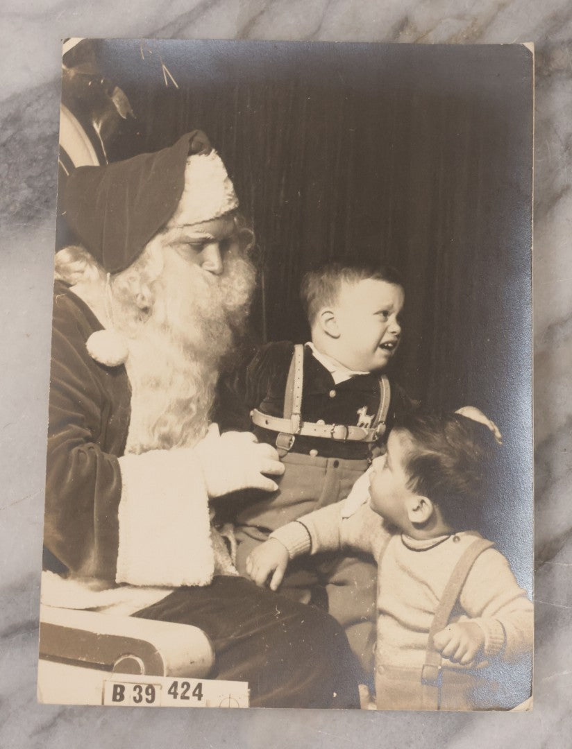 Lot 107 - Grouping Of Four Vintage Christmas Photographs Including Kids Scared Of Santa, And Photos By Christmas Tree