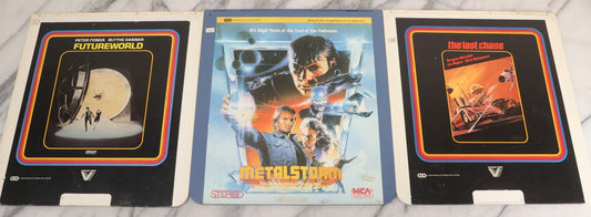 Lot 118 - Grouping Of Three Vintage Sci-Fi Movie Video Discs, Capacitance Electronic Disc (CED), Including "Futureworld" (1976), "The Last Chase" (1981), And "Metalstorm: The Destruction Of Jared-Syn" (1983)