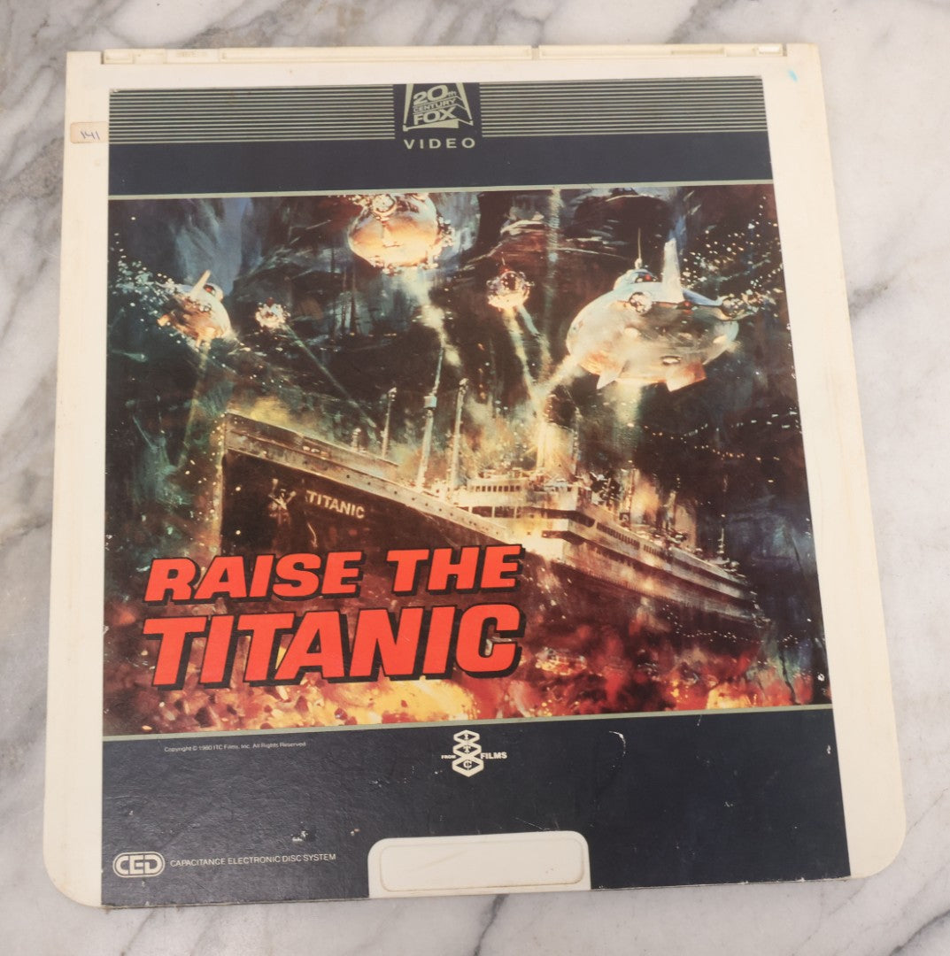 Lot 119 - Pair Of Vintage Nordical Adventure Movie Video Discs, Capacitance Electronic Disc (CED), Including "Raise The Titanic" (1980) And "The Poseidon Adventure" (1972)