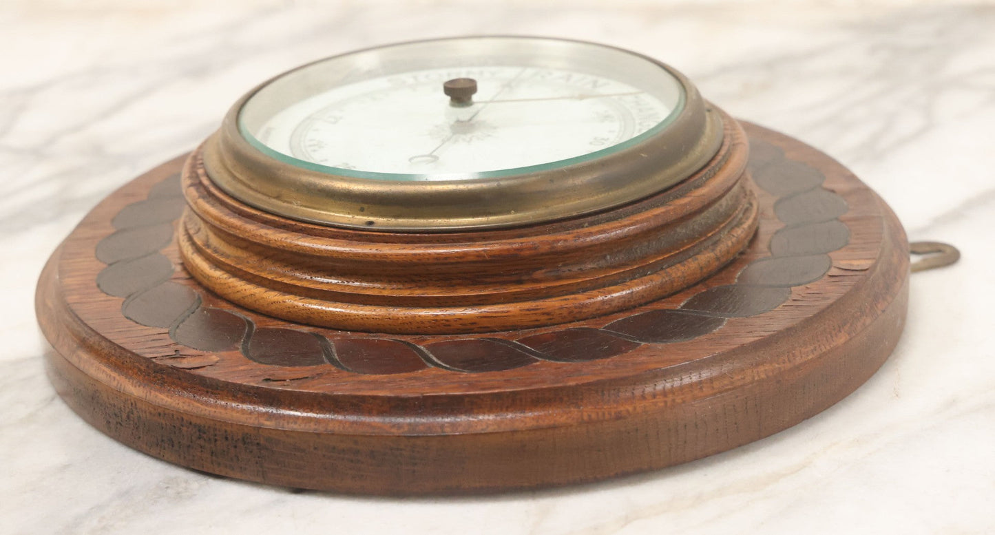 Lot 022 - Vintage Aneroid Barometer On Wood Plaque With Twisted Rope Inlay Motif, Beveled Glass Brass Surround, Wall Hanger, 9-3/4" Diameter