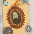 Lot 032 - Grouping Of Five Religious Devotional Smalls Including Prayer Card Of Unknown Nun With Lace Border, Four Metal Religious Charms
